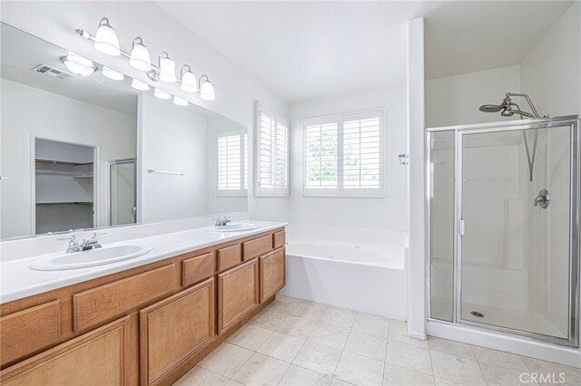 43839 58th St W, Lancaster, CA 93536 - bathroom featuring a stall shower, a bath, double vanity, and a spacious closet