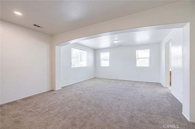 43839 58th St W, Lancaster, CA 93536 - carpeted empty room with arched walkways, baseboards, and recessed lighting