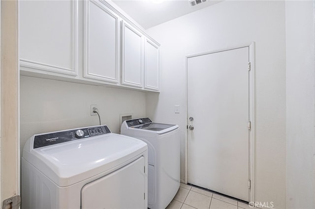 43839 58th St W, Lancaster, CA 93536 - washroom featuring washing machine and clothes dryer, cabinet space, and light tile patterned floors