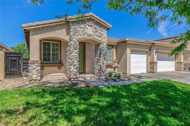 43839 58th St W, Lancaster, CA 93536 - mediterranean / spanish home featuring stucco siding, stone siding, an attached garage, concrete driveway, and a gate