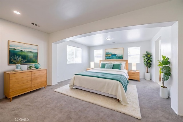 43839 58th St W, Lancaster, CA 93536 - bedroom featuring light carpet, arched walkways, and recessed lighting
