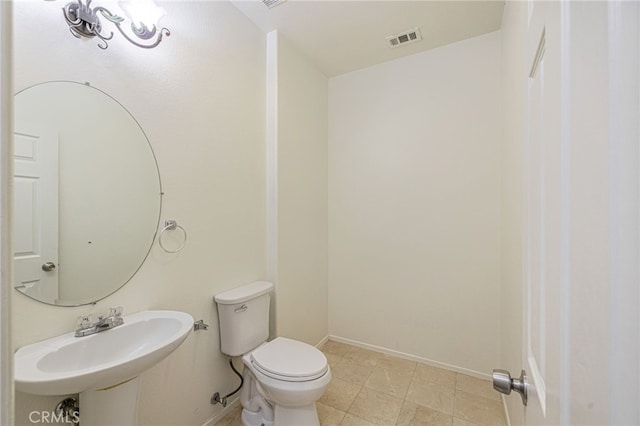43839 58th St W, Lancaster, CA 93536 - half bathroom featuring toilet, baseboards, and a sink
