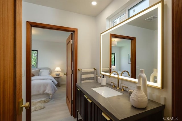 2136 Echo Park Ave, Los Angeles, CA 90026 - ensuite bathroom with wood finished floors, vanity, and recessed lighting