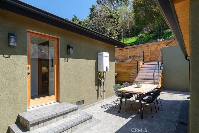 2136 Echo Park Ave, Los Angeles, CA 90026 - view of patio featuring outdoor dining area, stairway, and water heater