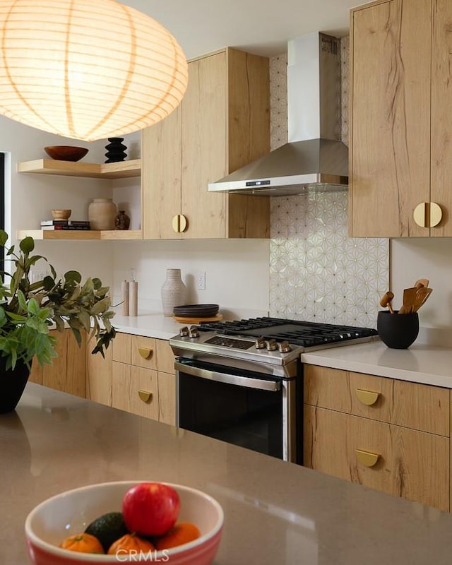 2136 Echo Park Ave, Los Angeles, CA 90026 - kitchen with wall chimney range hood, stainless steel range with gas stovetop, light brown cabinets, open shelves, and decorative backsplash