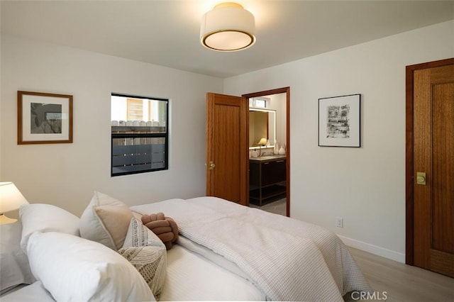 2136 Echo Park Ave, Los Angeles, CA 90026 - bedroom featuring light wood-style flooring, baseboards, and ensuite bathroom
