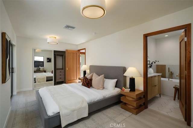 2136 Echo Park Ave, Los Angeles, CA 90026 - bedroom with light wood-style flooring, a closet, and ensuite bathroom