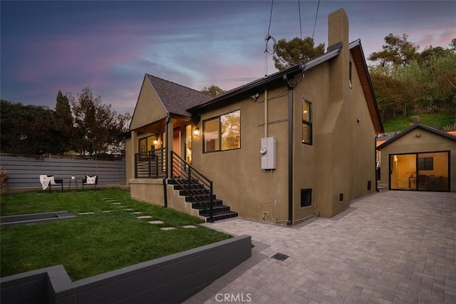 2136 Echo Park Ave, Los Angeles, CA 90026 - view of front facade with stucco siding, a lawn, a chimney, and an outdoor structure