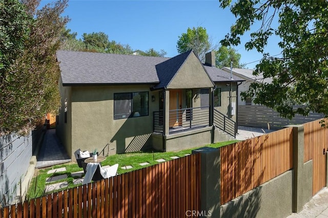 2136 Echo Park Ave, Los Angeles, CA 90026 - view of front of house with a fenced front yard, stucco siding, roof with shingles, and a chimney