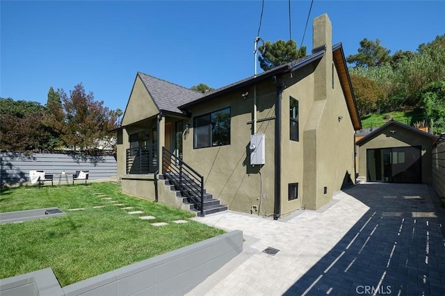 2136 Echo Park Ave, Los Angeles, CA 90026 - view of side of home with stucco siding, a yard, and a chimney