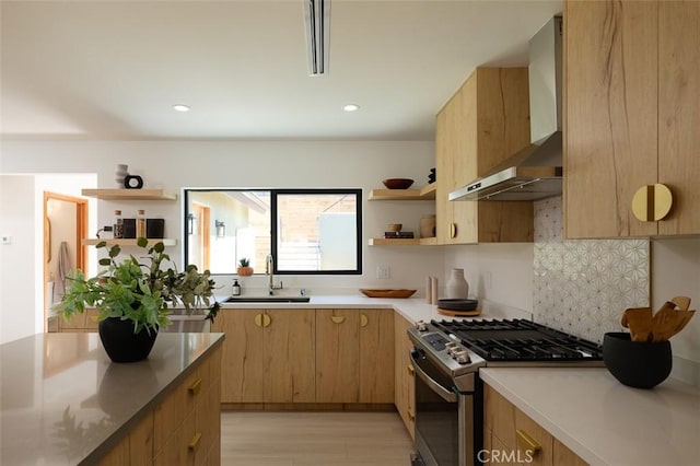 2136 Echo Park Ave, Los Angeles, CA 90026 - kitchen featuring stainless steel range with gas stovetop, a sink, wall chimney range hood, open shelves, and light wood-type flooring