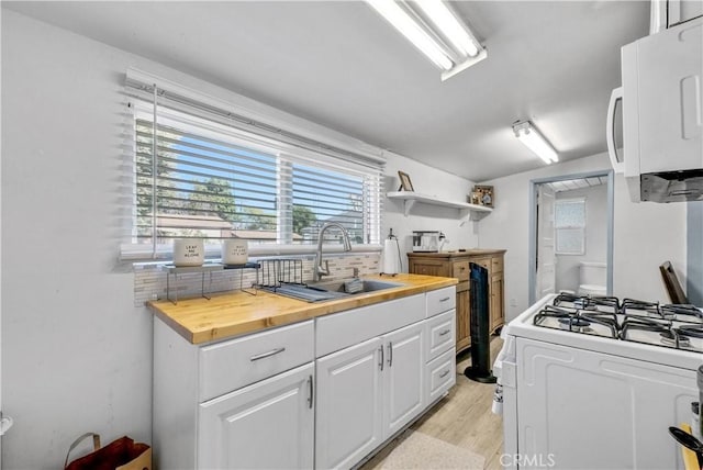 9446 La Grande St, Rancho Cucamonga, CA 91701 - kitchen with white appliances, butcher block countertops, a sink, white cabinetry, and light wood-type flooring