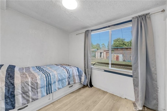 9446 La Grande St, Rancho Cucamonga, CA 91701 - bedroom featuring a textured ceiling and wood finished floors