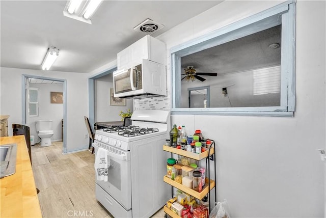 9446 La Grande St, Rancho Cucamonga, CA 91701 - kitchen featuring white appliances, ceiling fan, white cabinetry, light wood finished floors, and light countertops