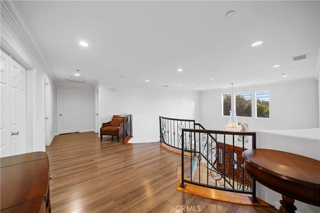 1621 Bryan Ave, Tustin, CA 92780 - hallway with an upstairs landing, ornamental molding, wood finished floors, and recessed lighting