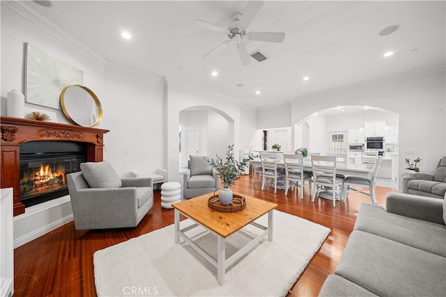 1621 Bryan Ave, Tustin, CA 92780 - living area with arched walkways, a ceiling fan, crown molding, a glass covered fireplace, and wood finished floors