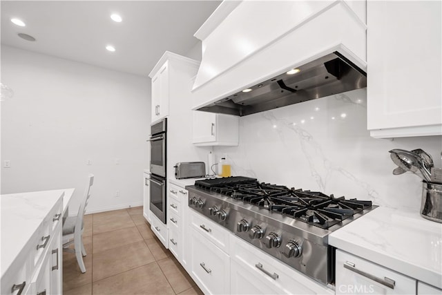 1621 Bryan Ave, Tustin, CA 92780 - kitchen with appliances with stainless steel finishes, custom exhaust hood, white cabinetry, light stone countertops, and recessed lighting