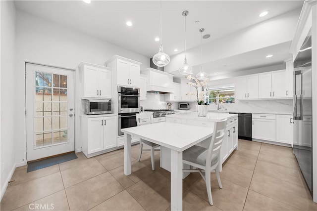 1621 Bryan Ave, Tustin, CA 92780 - kitchen with appliances with stainless steel finishes, a kitchen island, white cabinetry, recessed lighting, and light tile patterned floors