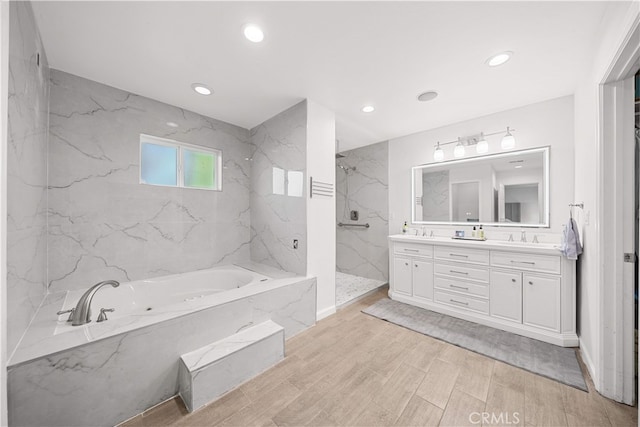 1621 Bryan Ave, Tustin, CA 92780 - full bathroom with double vanity, a garden tub, a marble finish shower, recessed lighting, and wood finished floors