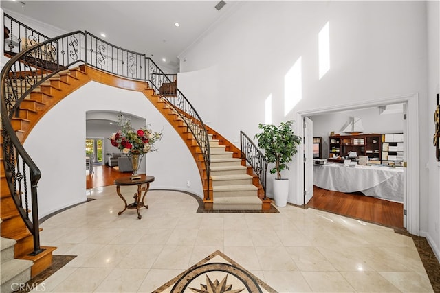 1621 Bryan Ave, Tustin, CA 92780 - entryway with stairway, a high ceiling, arched walkways, baseboards, and tile patterned floors