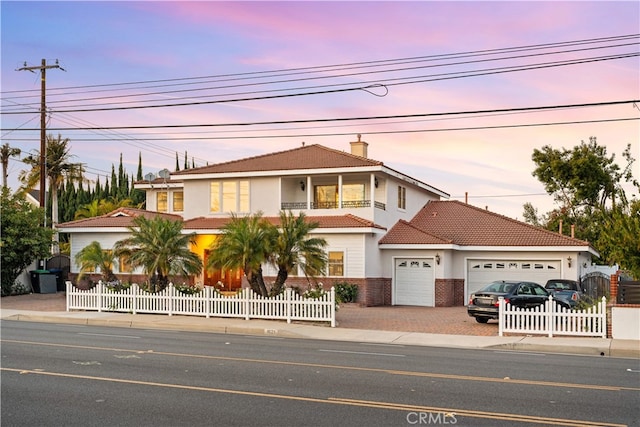 1621 Bryan Ave, Tustin, CA 92780 - mediterranean / spanish-style home featuring a garage, a fenced front yard, driveway, and a tile roof
