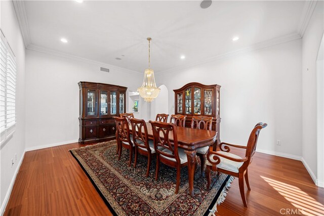 1621 Bryan Ave, Tustin, CA 92780 - dining area with a chandelier, wood finished floors, baseboards, recessed lighting, and crown molding