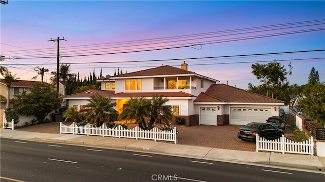 1621 Bryan Ave, Tustin, CA 92780 - view of front of house with a garage, driveway, a fenced front yard, stucco siding, and a tile roof