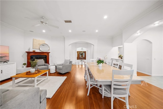 1621 Bryan Ave, Tustin, CA 92780 - dining area with arched walkways, ceiling fan, recessed lighting, light wood-style flooring, and crown molding