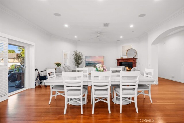 1621 Bryan Ave, Tustin, CA 92780 - dining space featuring a ceiling fan, arched walkways, ornamental molding, recessed lighting, and light wood-type flooring