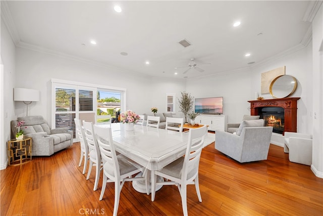 1621 Bryan Ave, Tustin, CA 92780 - dining space featuring light wood-style floors, ceiling fan, recessed lighting, ornamental molding, and a glass covered fireplace