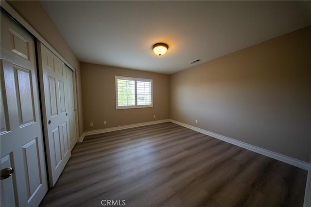 35197 Hogan Dr, Beaumont, CA 92223 - unfurnished bedroom featuring baseboards, dark wood-type flooring, and a closet