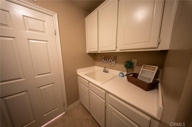 35197 Hogan Dr, Beaumont, CA 92223 - clothes washing area featuring a sink, light tile patterned floors, and baseboards