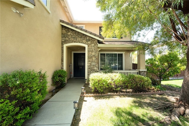35197 Hogan Dr, Beaumont, CA 92223 - view of exterior entry featuring stone siding, stucco siding, and a porch