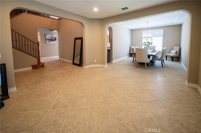 35197 Hogan Dr, Beaumont, CA 92223 - dining room featuring arched walkways, stairway, a chandelier, light tile patterned floors, and recessed lighting