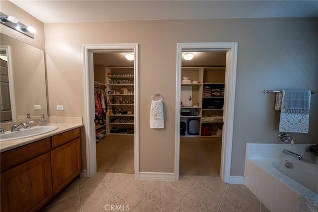 35197 Hogan Dr, Beaumont, CA 92223 - full bathroom with tile patterned floors, vanity, a walk in closet, and tiled tub