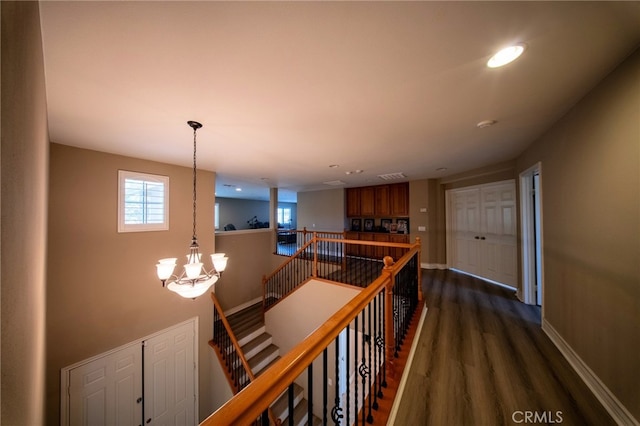 35197 Hogan Dr, Beaumont, CA 92223 - hall featuring an upstairs landing, dark wood-style floors, a chandelier, baseboards, and recessed lighting