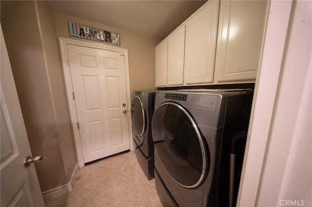 35197 Hogan Dr, Beaumont, CA 92223 - laundry area featuring washing machine and clothes dryer, light tile patterned floors, cabinet space, and baseboards