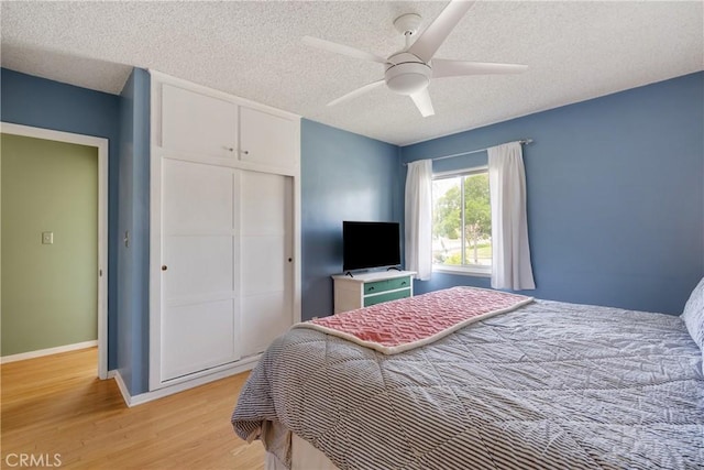 206 Underhill Dr, Glendora, CA 91741 - bedroom with a closet, a textured ceiling, light wood-style floors, baseboards, and ceiling fan