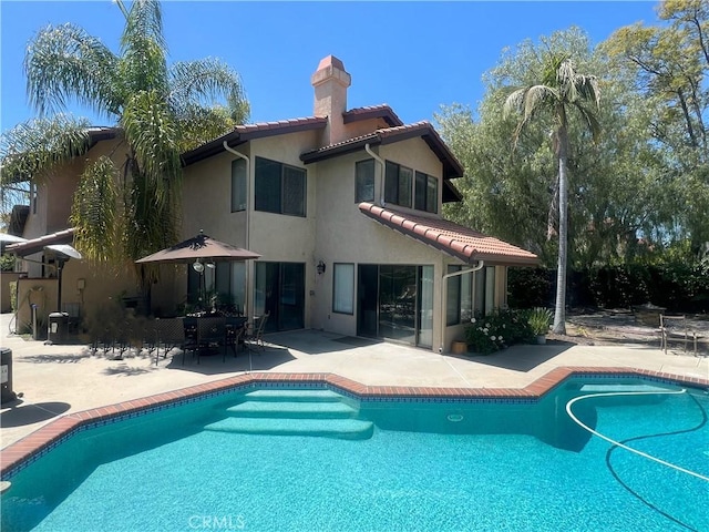 820 Rainwater Ln, Walnut, CA 91789 - rear view of house with a chimney, stucco siding, a patio, an outdoor pool, and a tiled roof