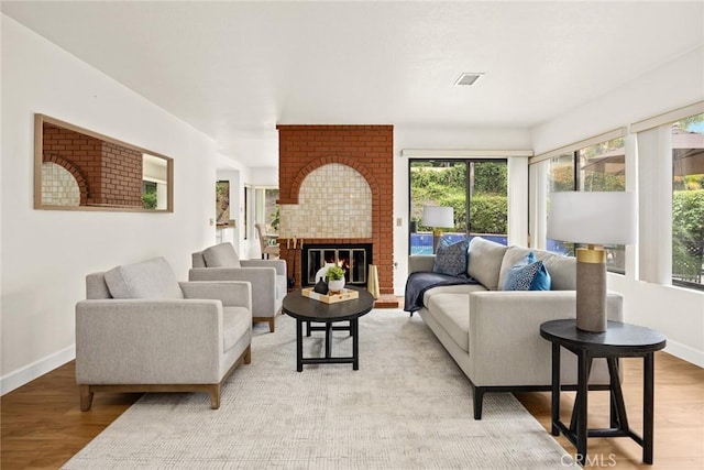 820 Rainwater Ln, Walnut, CA 91789 - living room featuring baseboards, light wood-style flooring, and a fireplace