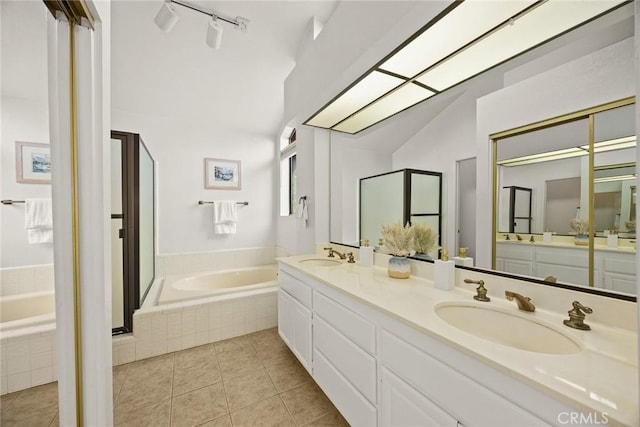 820 Rainwater Ln, Walnut, CA 91789 - bathroom with vaulted ceiling, a bath, double vanity, tile patterned floors, and a shower stall