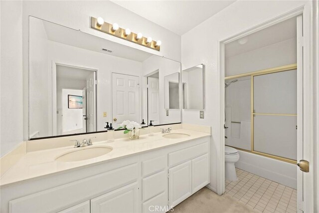 820 Rainwater Ln, Walnut, CA 91789 - bathroom featuring toilet, double vanity, tile patterned floors, and shower / bath combination with glass door