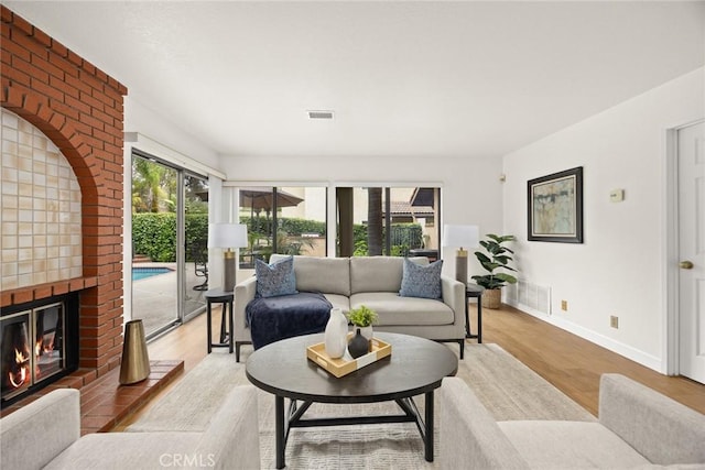 820 Rainwater Ln, Walnut, CA 91789 - living room with light wood-style floors, baseboards, and a brick fireplace
