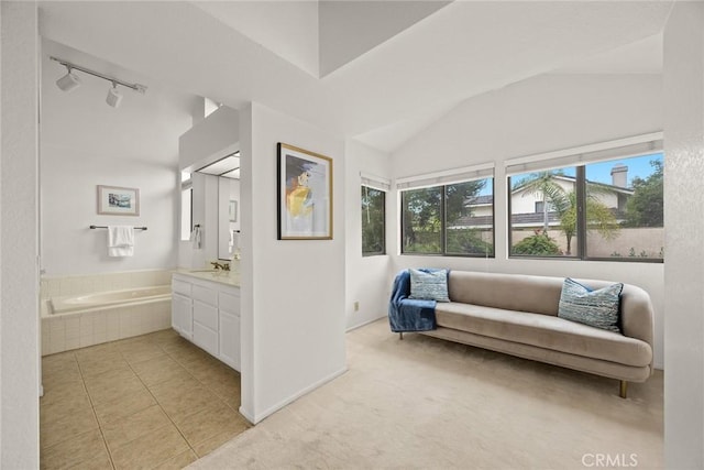 820 Rainwater Ln, Walnut, CA 91789 - sitting room with vaulted ceiling, rail lighting, light tile patterned flooring, and baseboards