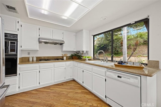 820 Rainwater Ln, Walnut, CA 91789 - kitchen featuring dishwasher, under cabinet range hood, a sink, gas stovetop, and light wood-style floors