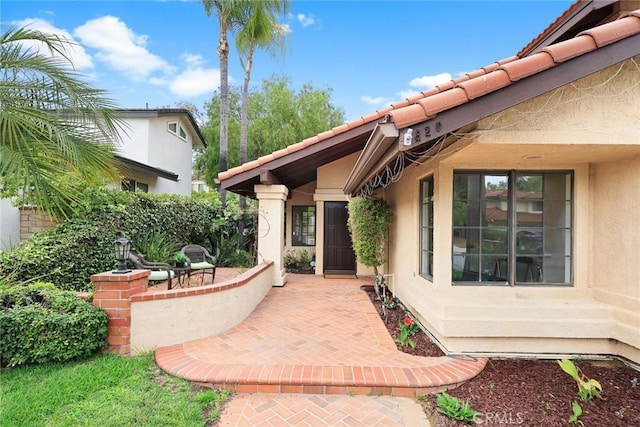 820 Rainwater Ln, Walnut, CA 91789 - entrance to property with stucco siding, a tile roof, and a patio