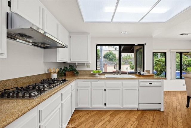 820 Rainwater Ln, Walnut, CA 91789 - kitchen featuring under cabinet range hood, a sink, white dishwasher, stainless steel gas stovetop, and light wood-style flooring