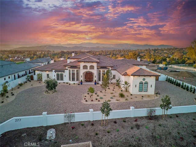 277 Crestview Ave, Camarillo, CA 93010 - mediterranean / spanish home with a tile roof, a fenced front yard, stucco siding, a chimney, and a mountain view