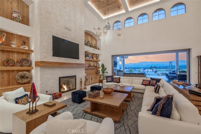 277 Crestview Ave, Camarillo, CA 93010 - living area featuring a towering ceiling, built in features, healthy amount of natural light, and a stone fireplace