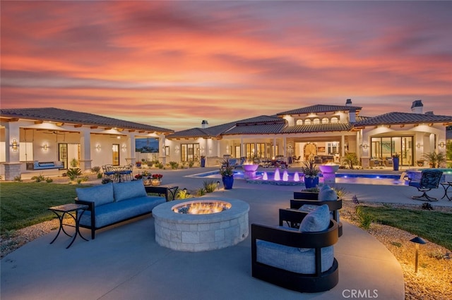 277 Crestview Ave, Camarillo, CA 93010 - patio terrace at dusk featuring an outdoor pool and an outdoor living space with a fire pit